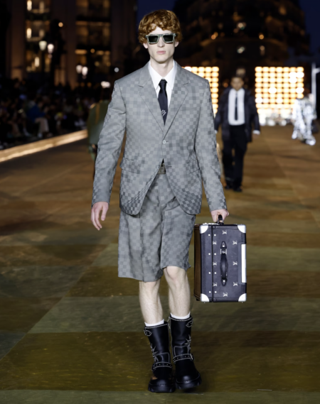 Model walking down the runway in a suit ensemble at Louis Vuitton.